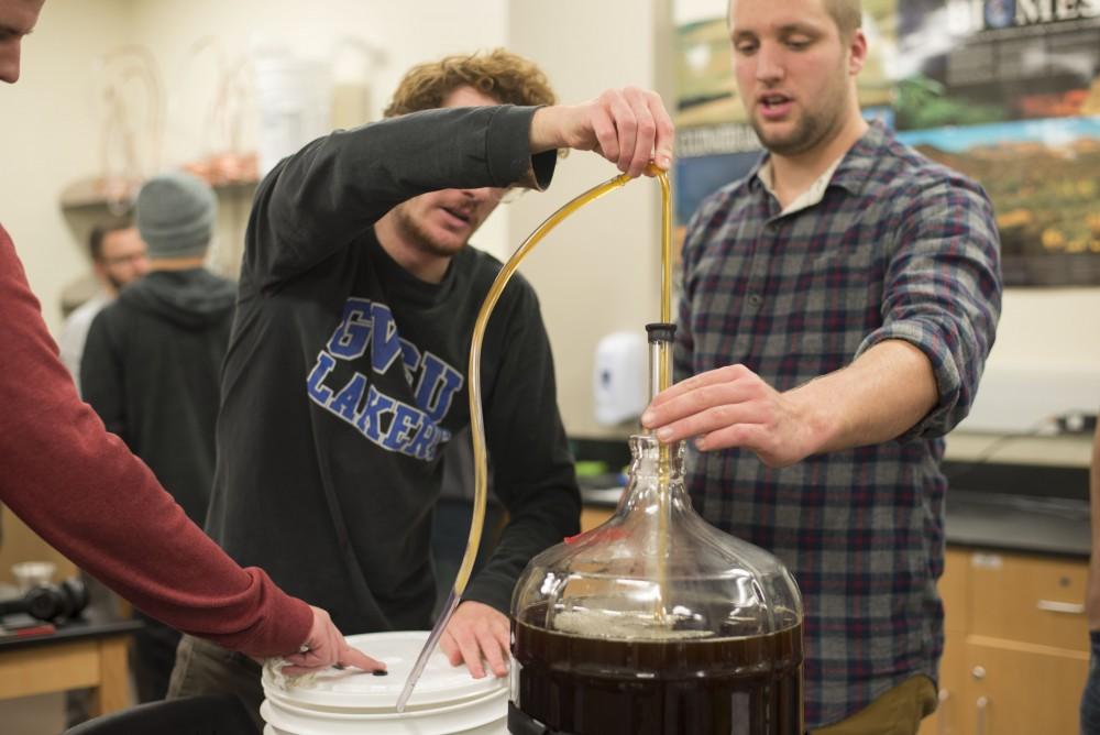 GVL / Luke Holmes - Zack Drescher (left) and Devon Schumaker (right) work on their brew. Biology professor, Mark Staves, teaches the CMB 350 Foundations of Brewing course. 