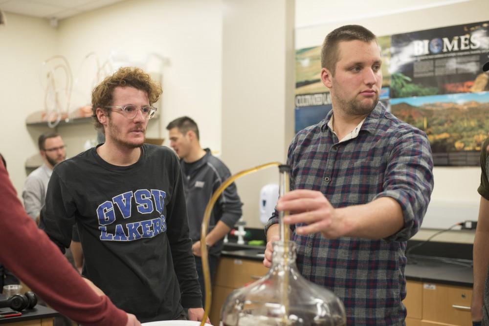 GVL / Luke Holmes - Zack Drescher (left) and Devon Schumaker (right) work on their brew. Biology professor, Mark Staves, teaches the CMB 350 Foundations of Brewing course. 