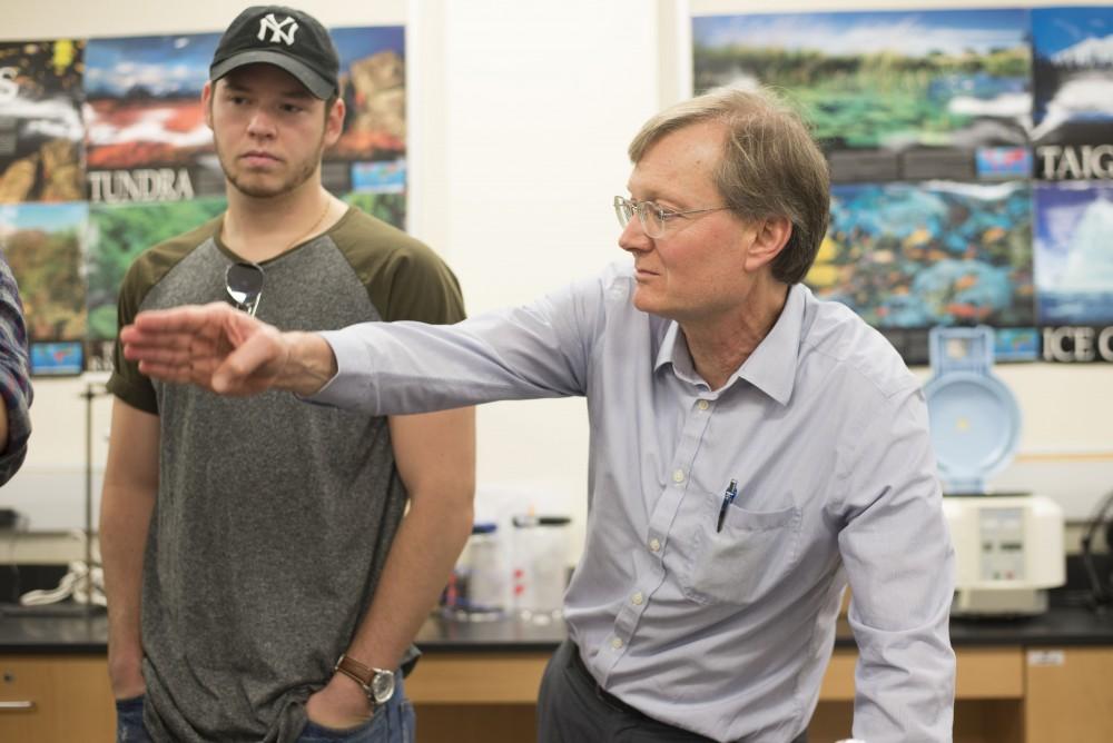 GVL / Luke Holmes - Biology professor, Mark Staves, helps his students with their brew in the Foundations of Brewing course.