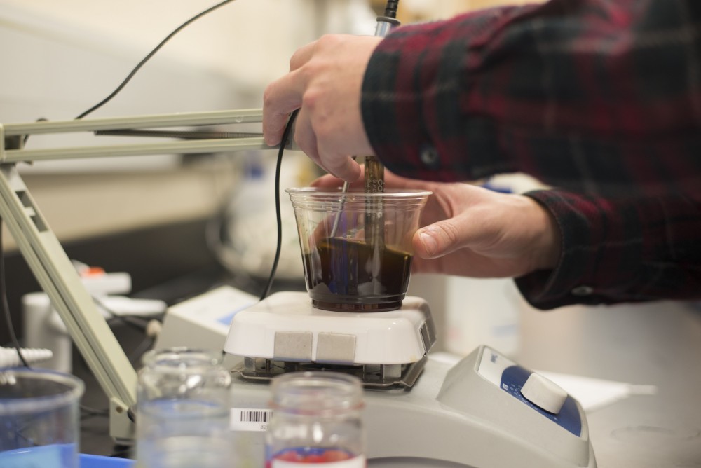 GVL / Luke Holmes - Kyle Anderson performs a test on his beer. Biology professor, Mark Staves, teaches the CMB 350 Foundations of Brewing course. 