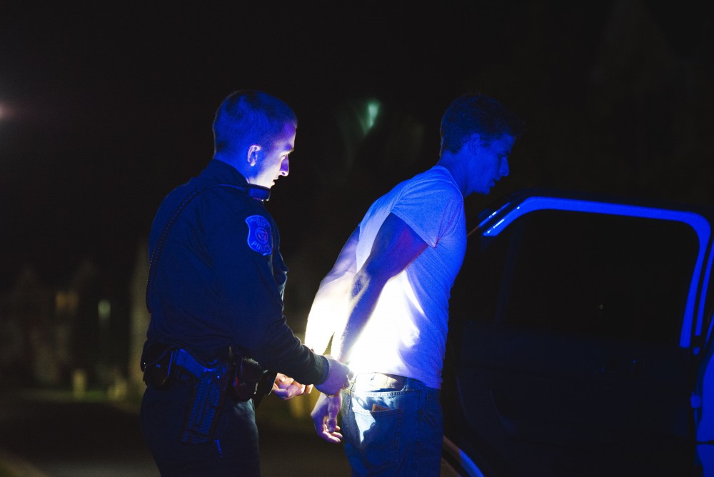 GVL / Luke Holmes - Officer Beelen detains a subject. The ride along with Sergeant Jeff Stoll took place on Saturday, Oct. 29, 2016.