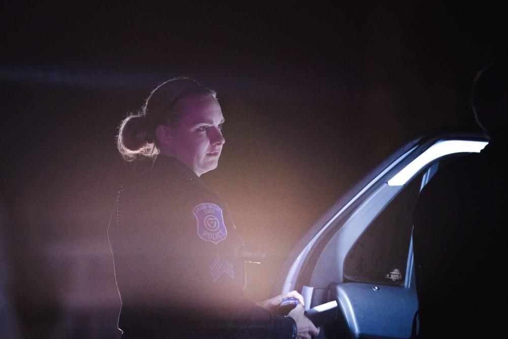 GVL / Luke Holmes - Sergeant Heaton talks to Officer Beelen after detaining a subject. The ride along with Sergeant Jeff Stoll took place on Saturday, Oct. 29, 2016.