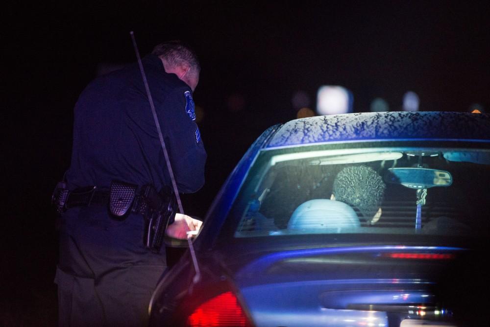 GVL / Luke Holmes - Sergeant Stoll makes a traffic stop on Lake Michigan Drive. The ride along with Sergeant Jeff Stoll took place on Saturday, Oct. 29, 2016.