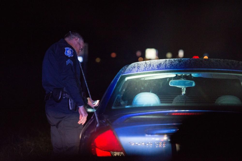 GVL / Luke Holmes - Sergeant Stoll makes a traffic stop on Lake Michigan Drive. The ride along with Sergeant Jeff Stoll took place on Saturday, Oct. 29, 2016.