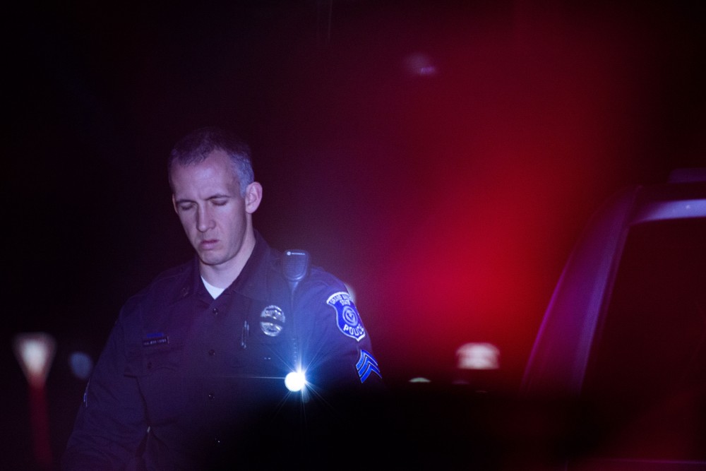 GVL / Luke Holmes - Sergeant Stoll returns to his car. The ride along with Sergeant Jeff Stoll took place on Saturday, Oct. 29, 2016.