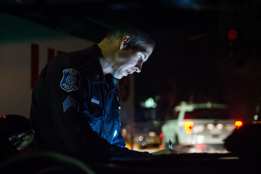 GVL / Luke Holmes - Sergeant Stoll writes down information into his notepad at the scene of a medical emergency. The ride along with Sergeant Jeff Stoll took place on Saturday, Oct. 29, 2016.