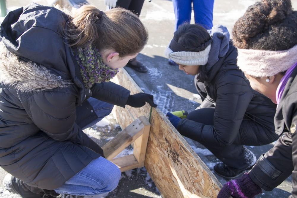 GVL/Sara Carte - Grand Valley students help build Cherry Street Park’s new ice rink for the Martin Luther King community service projects on Friday, Jan. 22, 2016.