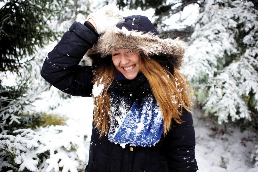 GVL/Emily Frye - GVSU senior Emily Schroer poses for a photo as snow falls on Saturday, Nov. 21, 2015.  