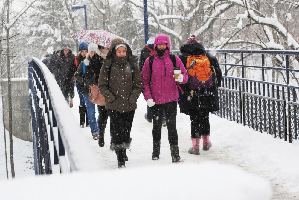 GVL/Archive - Students walk across the Little Mac bridge on a snowy Saturday, Dec. 13, 2015.