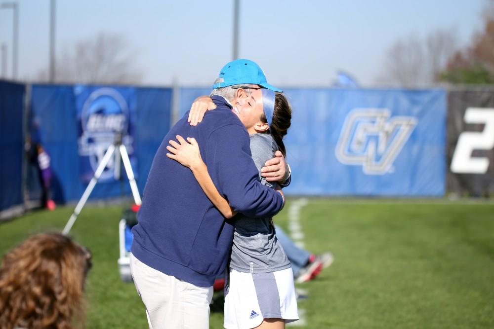 GVL / Emily Frye 
Dani Johnson hugs family before the start of the GLIAC Conference Championship on Sunday Nov. 6, 2016. 