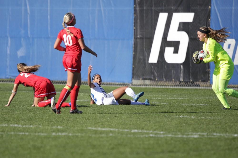 GVL / Luke Holmes - Jayma Martin (12) falls after a questionable slide tackle. GVSU Women's Soccer won 2-0 against Missouri St. Louis on Sunday, Nov. 13, 2016.