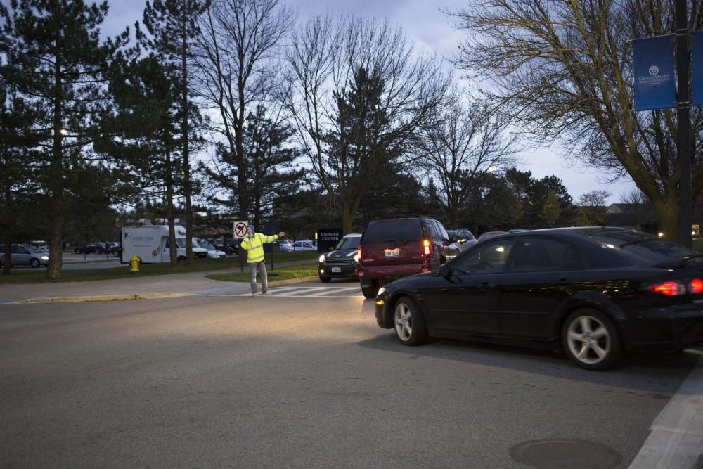 GVL / Sara Carte 
Cross walk attendant, Alex Putkovich, guides traffic on Grand Valley’s Allendale Campus on Tuesday, Nov. 8, 2016.