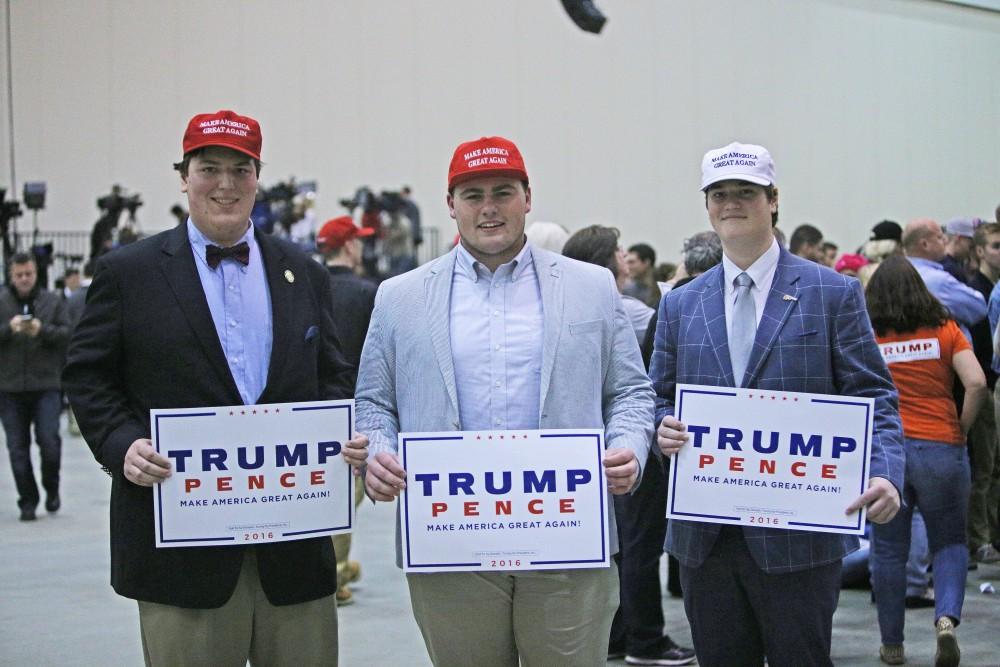 GVL / Emily Frye 
George Dines (left), Nic Lloye (center) and Alexander Dines (right) during the rally on Monday Nov. 7, 2016