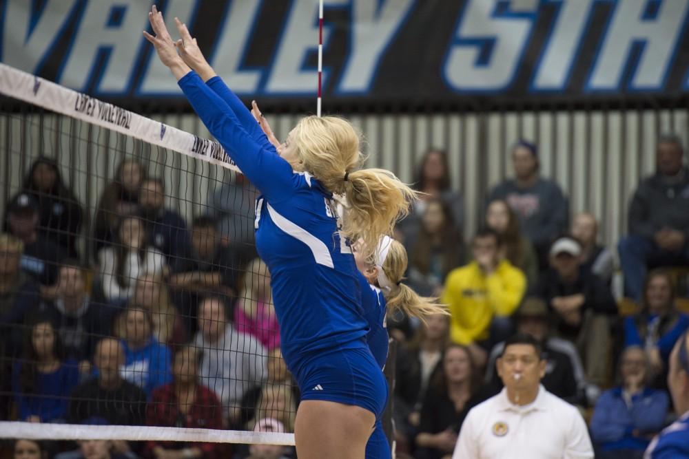 GVL / Luke Holmes - Staci Brower (21) jumps to block the incoming ball. GVSU volleyball defeated Northwood in three games in the Fieldhouse Arena on Friday, Nov. 11, 2016.