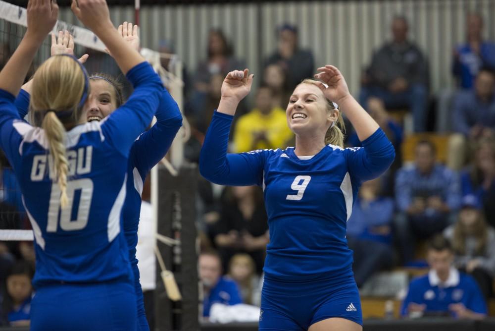 GVL / Luke Holmes - The team celebrates after scoring. GVSU volleyball defeated Northwood in three games in the Fieldhouse Arena on Friday, Nov. 11, 2016.