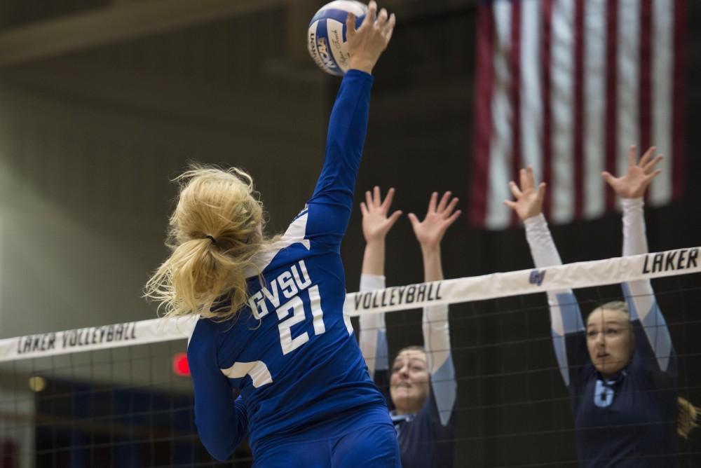 GVL / Luke Holmes - Staci Brower (21) jumps up and spikes the ball. GVSU volleyball defeated Northwood in three games in the Fieldhouse Arena on Friday, Nov. 11, 2016.