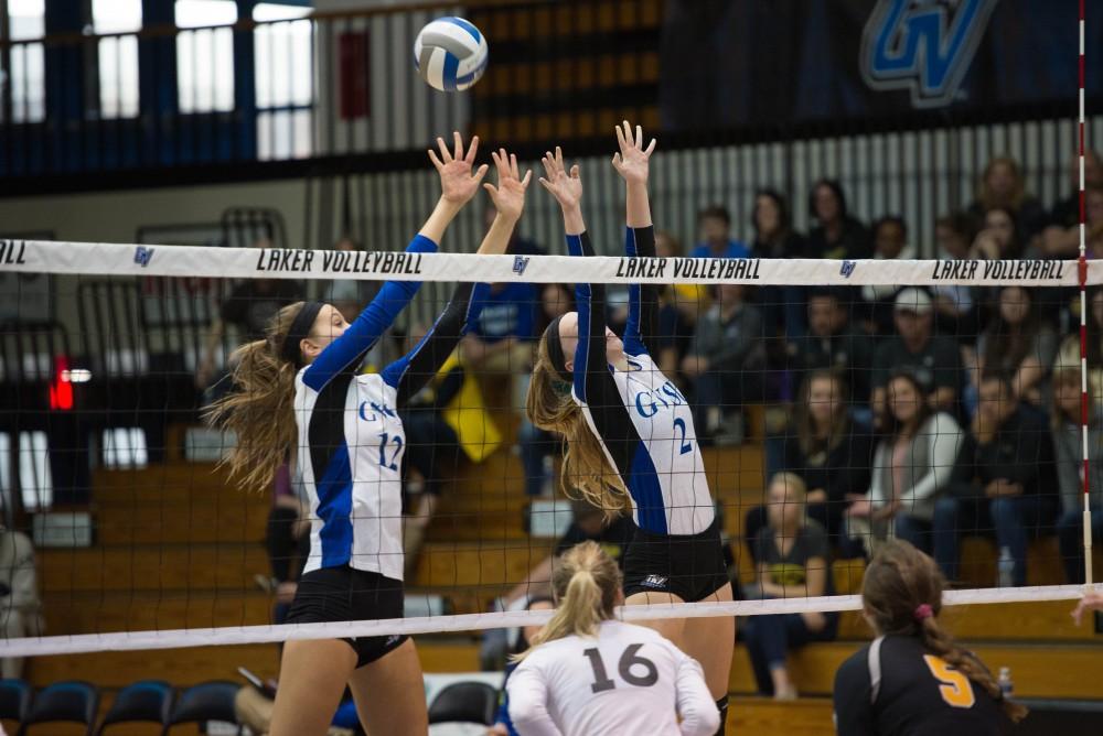 GVL / Luke Holmes - Jillian Butsavich (12) and Kendall Yerkes (2) block the incoming spike. GVSU volleyball lost to Michigan Tech on Saturday, Oct. 29. 2016.