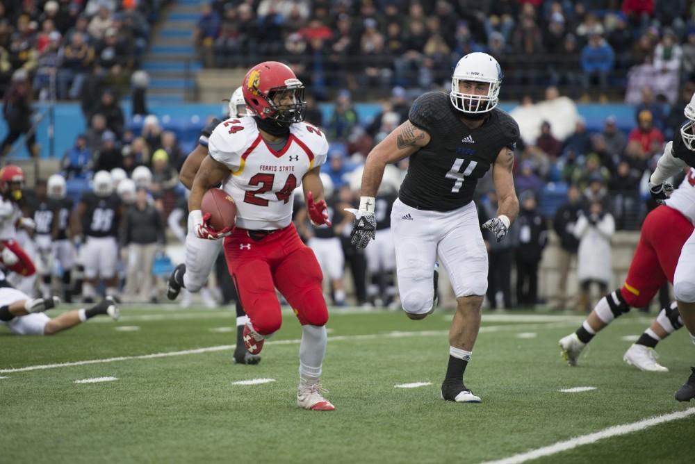 GVL / Luke Holmes - Alton Voss (4) runs after the runningback. GVSU lost to Ferris State in Lubbers Stadium on Saturday, Dec. 3, 2016.