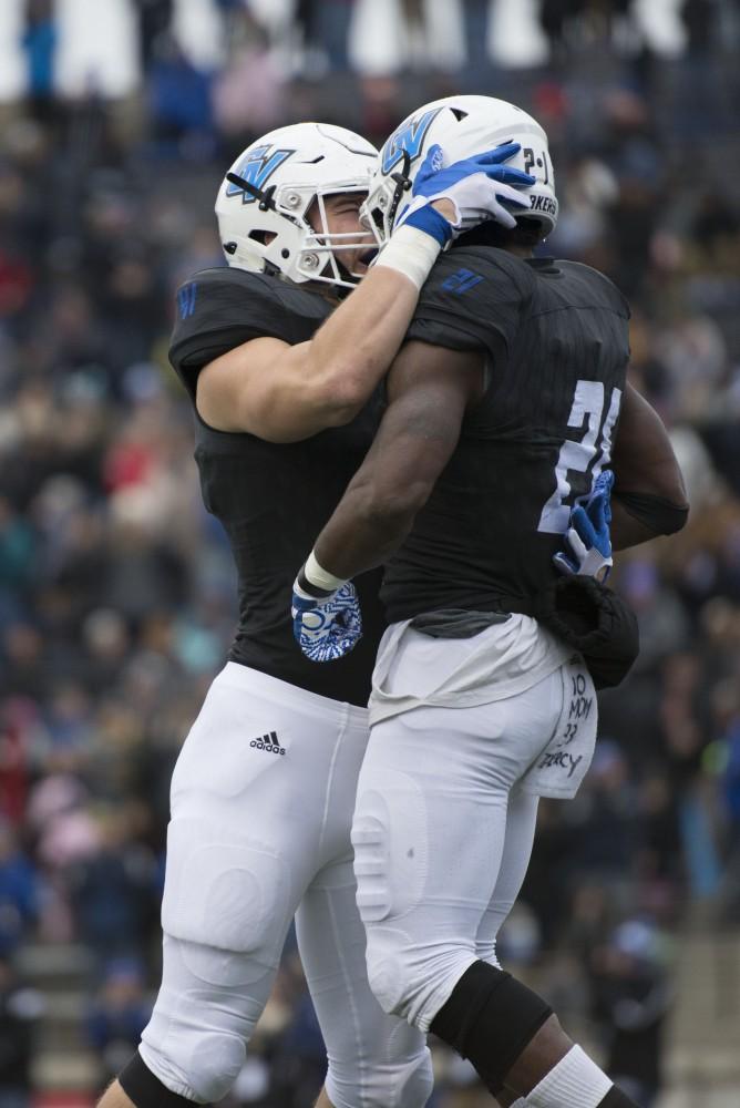 GVL / Luke Holmes - Nick Keizer (41) celebrates with Marty Carter (21) after scoring. GVSU lost to Ferris State in Lubbers Stadium on Saturday, Dec. 3, 2016.