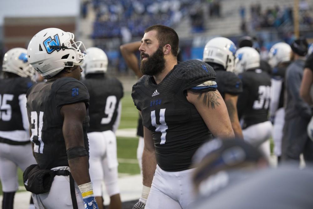 GVL / Luke Holmes - Alton Voss (4) hangs with his teammates on the sideline. GVSU lost to Ferris State in Lubbers Stadium on Saturday, Dec. 3, 2016.