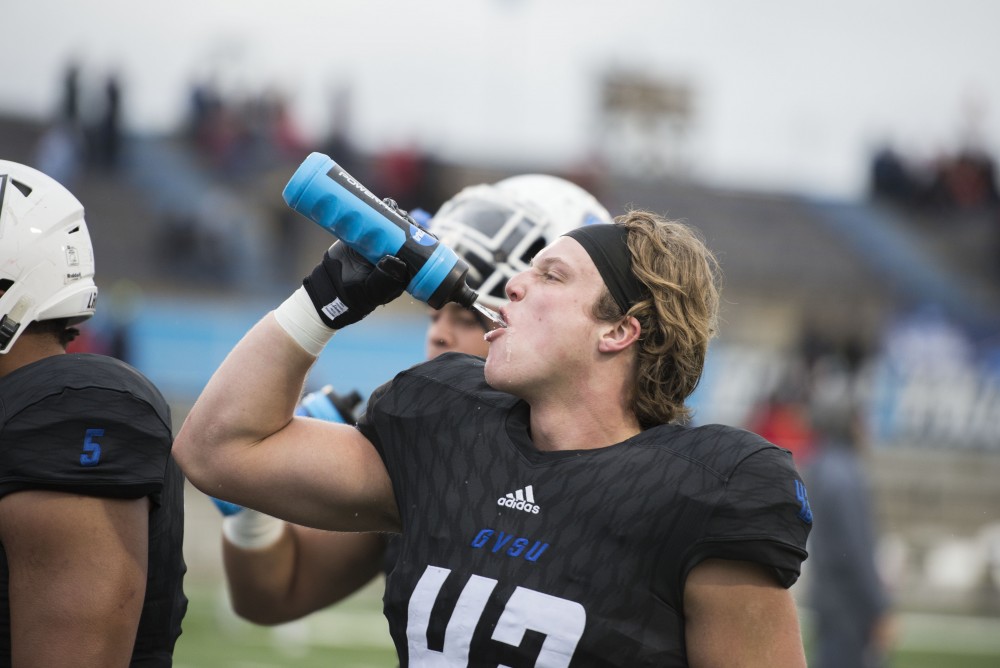 GVL / Luke Holmes - Jacob Howe (43) gets a drink of water during warm-up.GVSU lost to Ferris State in Lubbers Stadium on Saturday, Dec. 3, 2016.