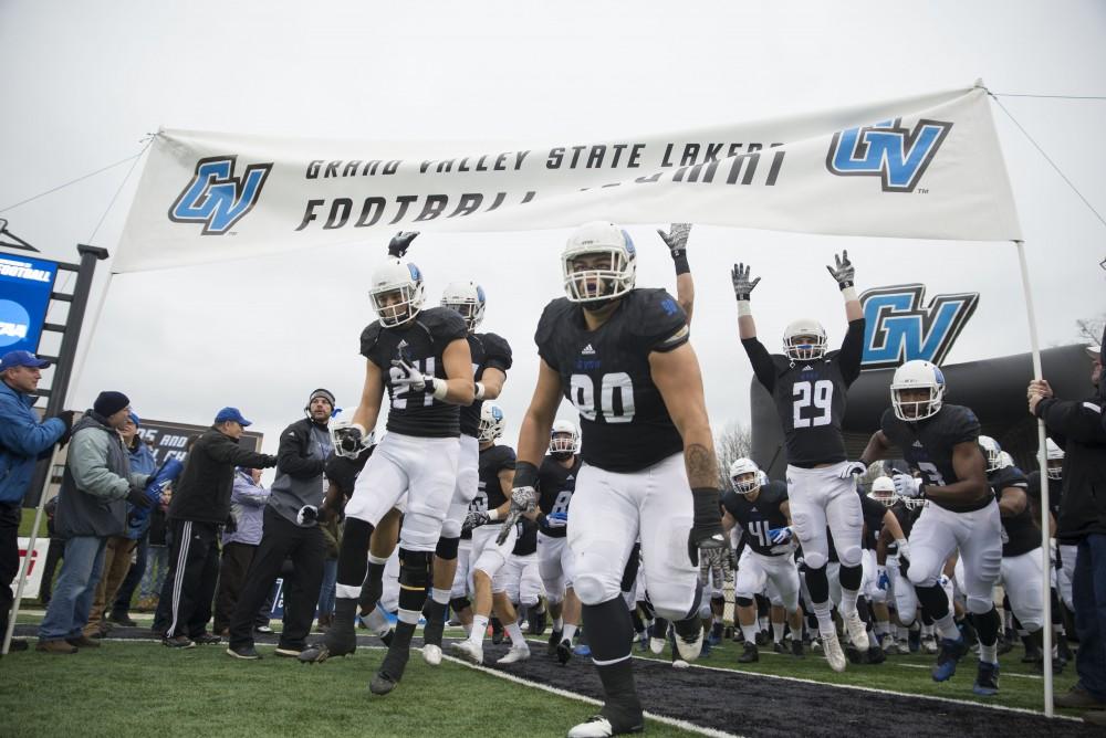 GVL / Luke Holmes - Players charge on to the field. GVSU lost to Ferris State in Lubbers Stadium on Saturday, Dec. 3, 2016.