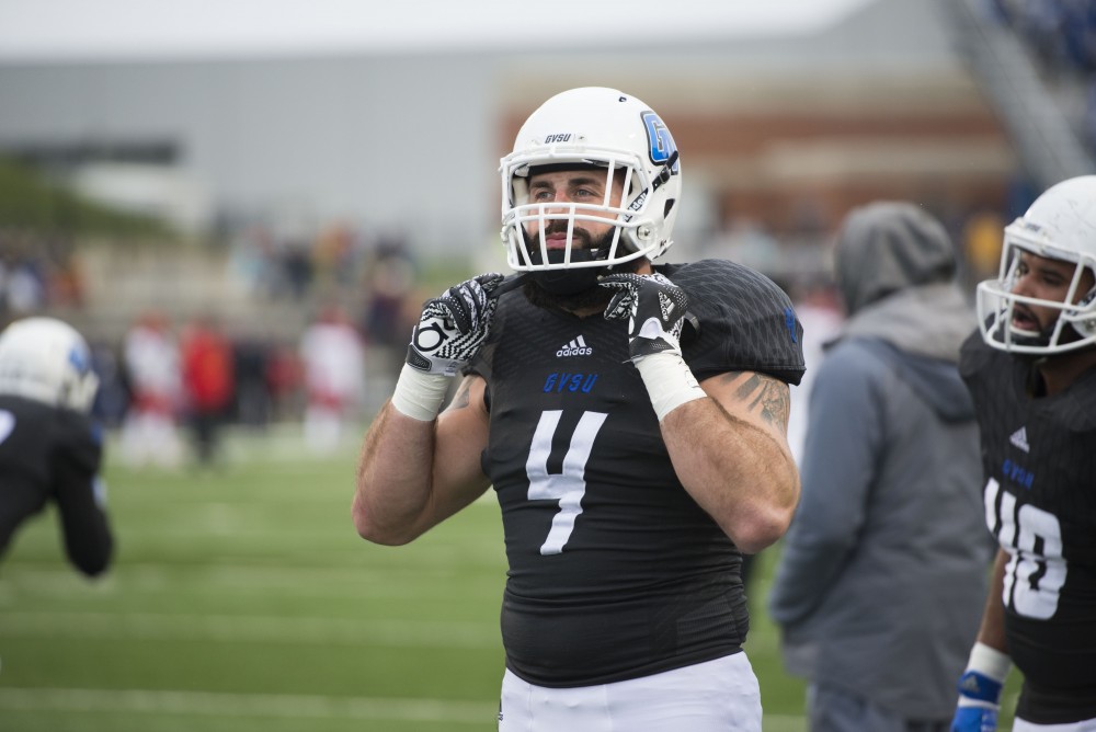 GVL / Luke Holmes - Alton Voss (4) adjusts his helmet during warm-up. GVSU lost to Ferris State in Lubbers Stadium on Saturday, Dec. 3, 2016.