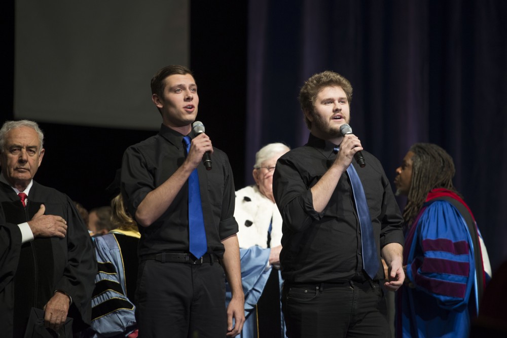 GVL / Luke Holmes - Casey Huls and Austin Schippers sing the national anthem. GVSU commencement was held in Van Andel Arena on Saturday, Dec. 10, 2016.