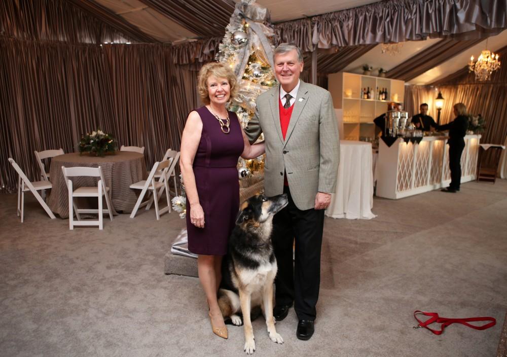 GVL / Emily Frye 
President Thomas Haas and First Lady Marcia Haas pose for a holiday photo with their dog Laker on Sunday Dec. 11, 2016