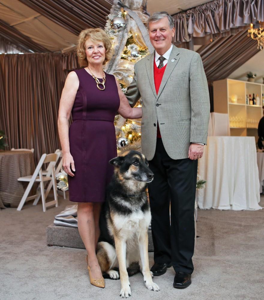 GVL / Emily Frye 
President Thomas Haas and First Lady Marcia Haas pose for a holiday photo with their dog Laker on Sunday Dec. 11, 2016