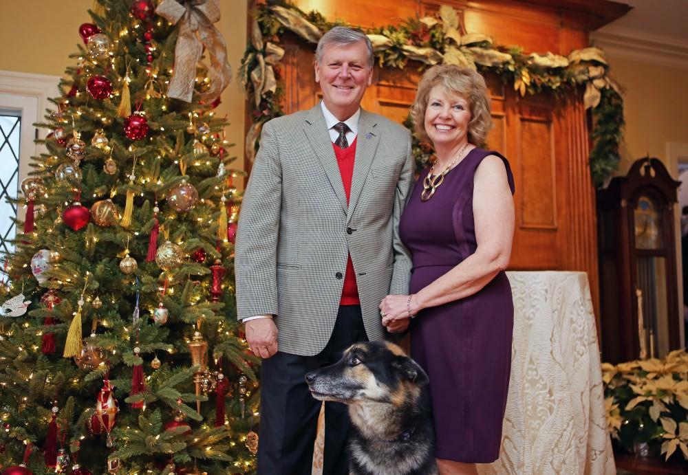 GVL / Emily Frye 
President Thomas Haas and First Lady Marcia Haas pose for a holiday photo with their dog Laker on Sunday Dec. 11, 2016