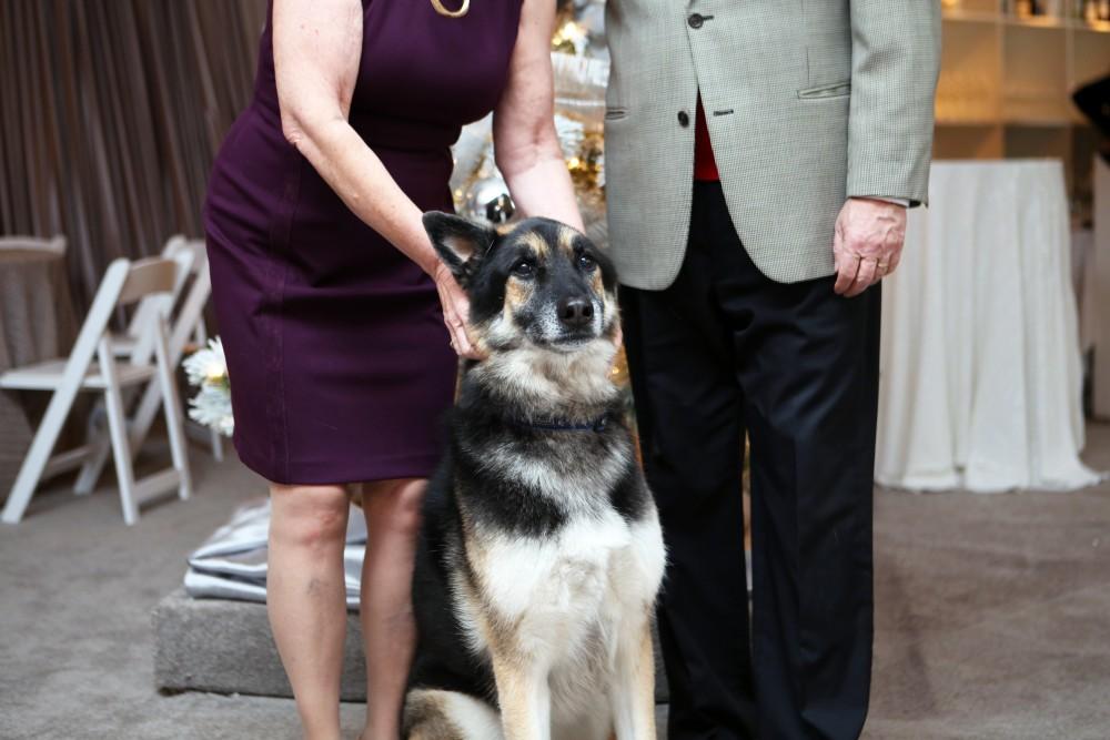 GVL / Emily Frye 
President Thomas Haas and First Lady Marcia Haas pose for a holiday photo with their dog Laker on Sunday Dec. 11, 2016