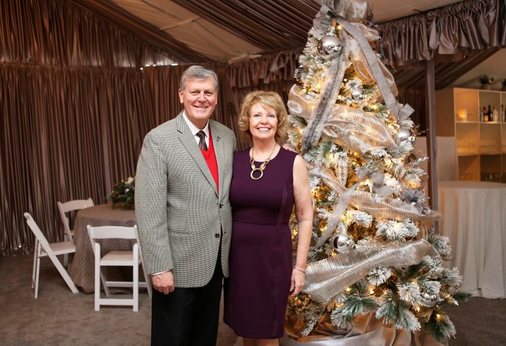 GVL / Emily Frye 
President Thomas Haas and First Lady Marcia Haas pose for a holiday photo with their dog Laker on Sunday Dec. 11, 2016