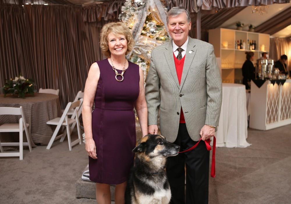 GVL / Emily Frye 
President Thomas Haas and First Lady Marcia Haas pose for a holiday photo with their dog Laker on Sunday Dec. 11, 2016