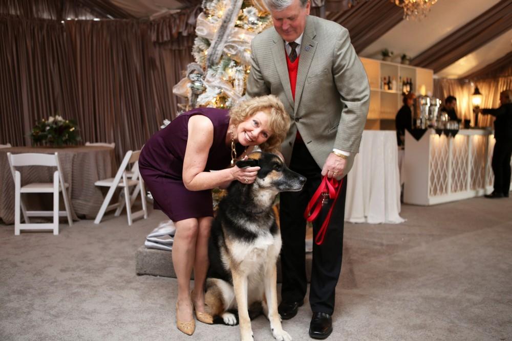 GVL / Emily Frye 
President Thomas Haas and First Lady Marcia Haas pose for a holiday photo with their dog Laker on Sunday Dec. 11, 2016