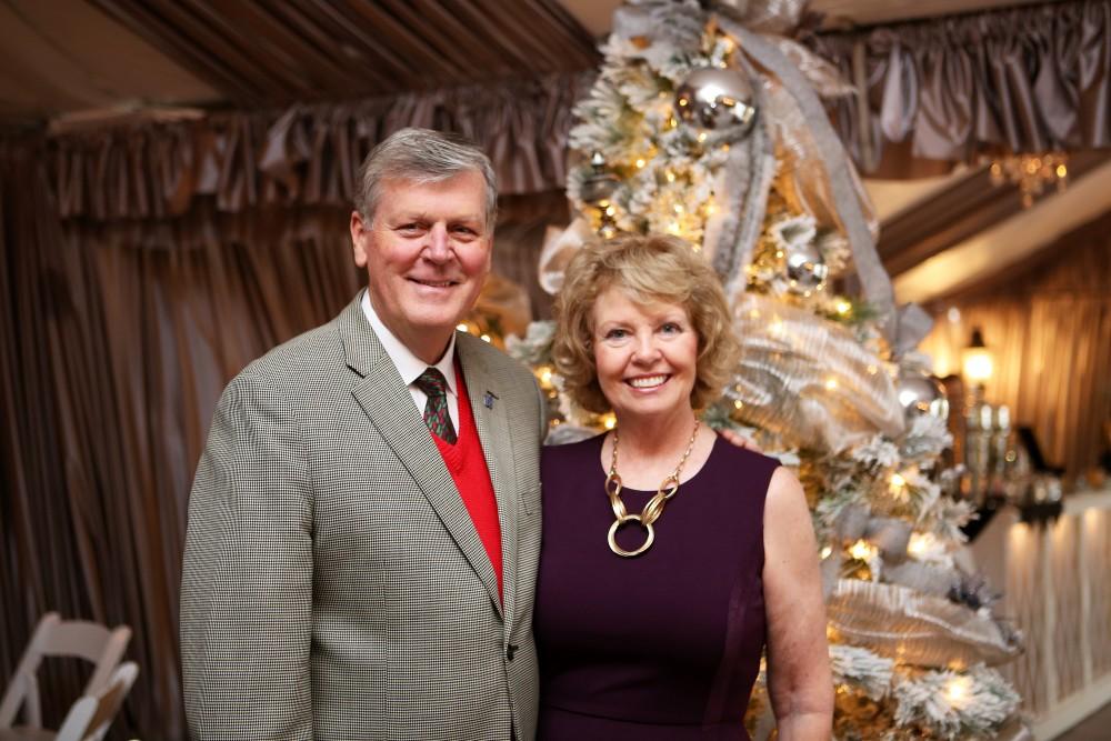 GVL / Emily Frye 
President Thomas Haas and First Lady Marcia Haas pose for a holiday photo with their dog Laker on Sunday Dec. 11, 2016