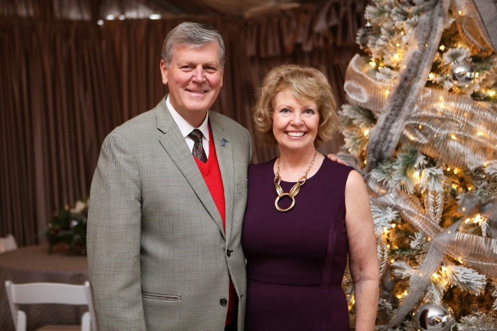 GVL / Emily Frye 
President Thomas Haas and First Lady Marcia Haas pose for a holiday photo with their dog Laker on Sunday Dec. 11, 2016