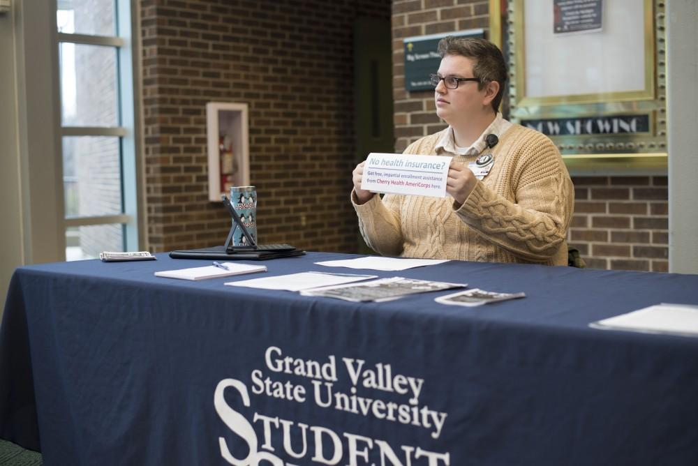 GVL / Luke Holmes - Leslie Boker offers health insurance information in Kirkhof on Thursday, Dec. 1, 2016.