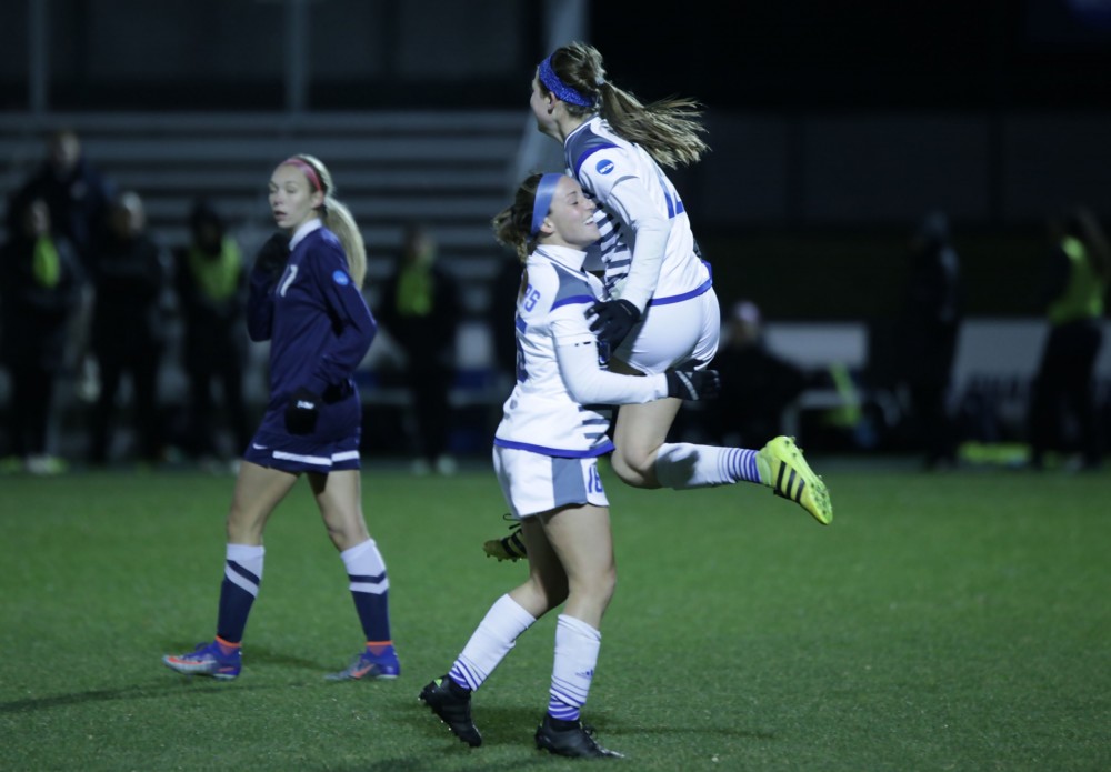 GVL / Emily Frye 
Marti Corby celebrates with Dani Johnson after Corby's second goal during the semi final game on Thursday Dec. 1, 2016. 