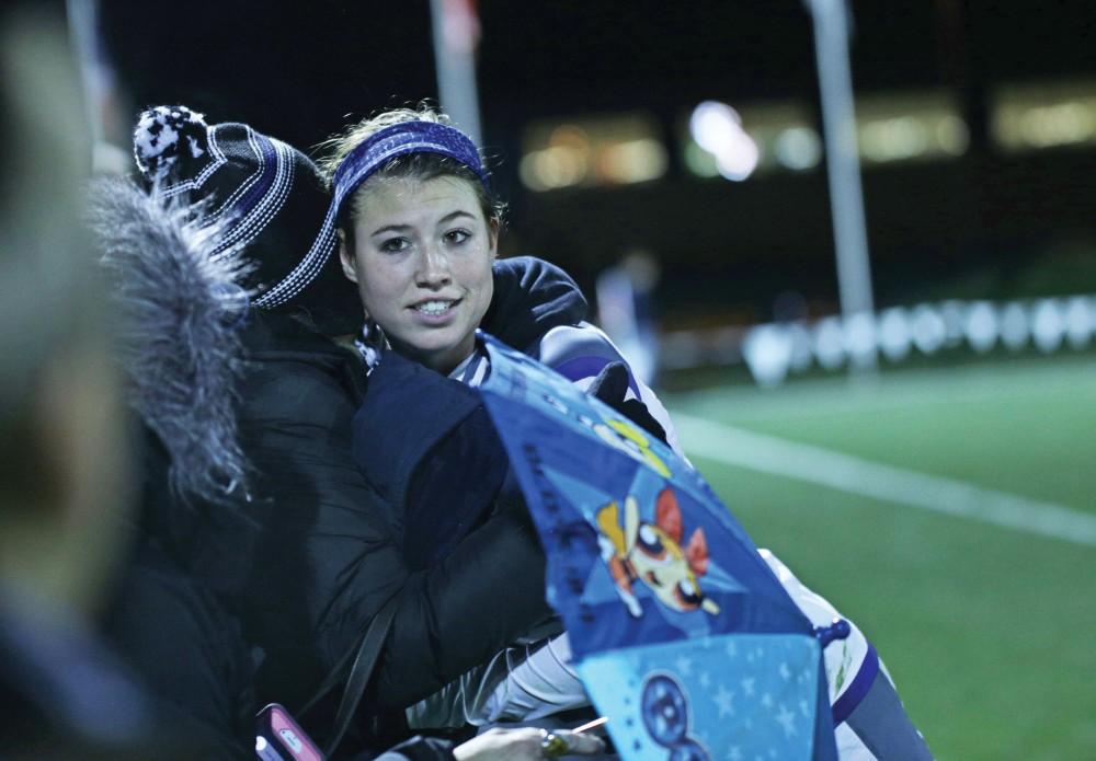 GVL / Emily Frye
Marti Corby hugs family after the Lakers win during the semi final round on Thursday Dec. 1, 2016. 