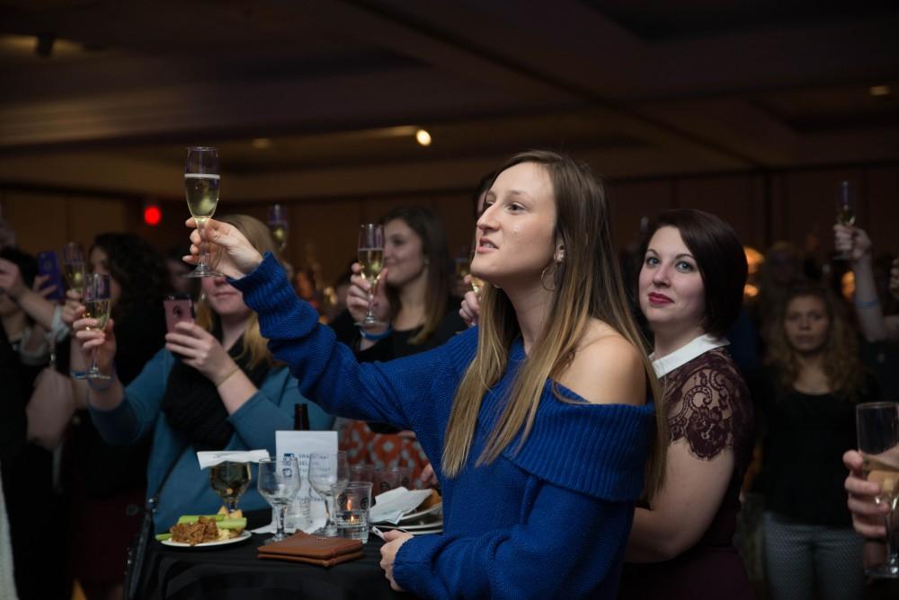 GVL / Luke Holmes - Students raise a glass to graduating. Students celebrated a "Toast with T. Haas" in the Eberhard Center on Thursday, Dec. 8, 2016.