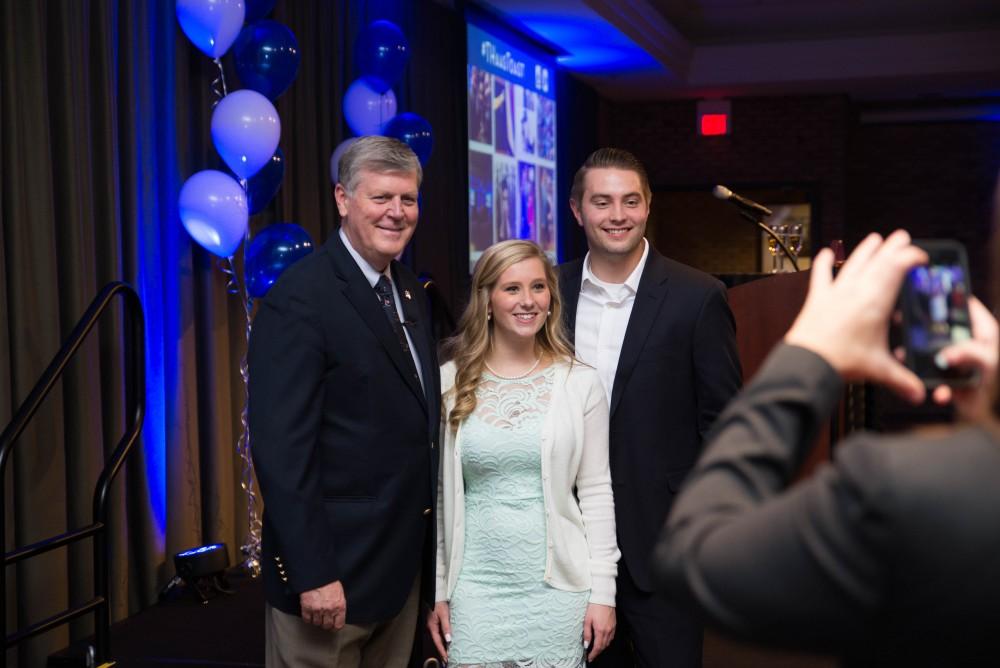 GVL / Luke Holmes - Students pose for a photo with T. Haas. Students celebrate a "Toast with T. Haas" in the Eberhard Center on Thursday, Dec. 8, 2016.