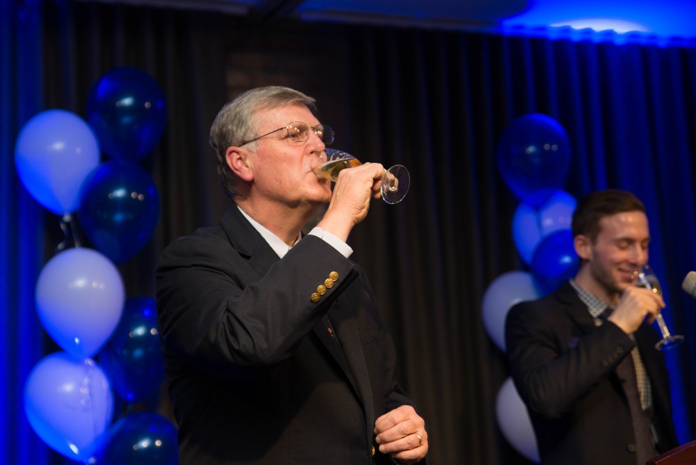 GVL / Luke Holmes - President T. Haas takes a sip of his champagne. Students celebrate a "Toast with T. Haas" in the Eberhard Center on Thursday, Dec. 8, 2016.