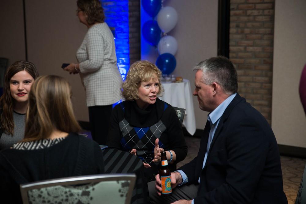 GVL / Luke Holmes - Marcia Haas socializes before the event starts. Students celebrate a "Toast with T. Haas" in the Eberhard Center on Thursday, Dec. 8, 2016.