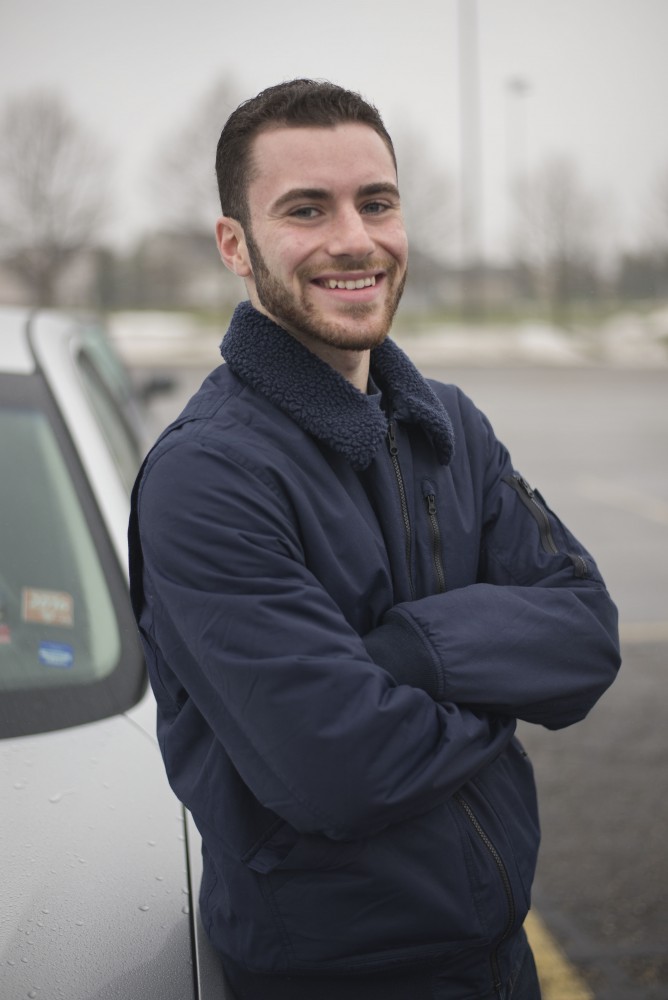 GVL / Luke Holmes - Aaron Robert poses in the parking lot outside of the Mary Idema Pew Library.