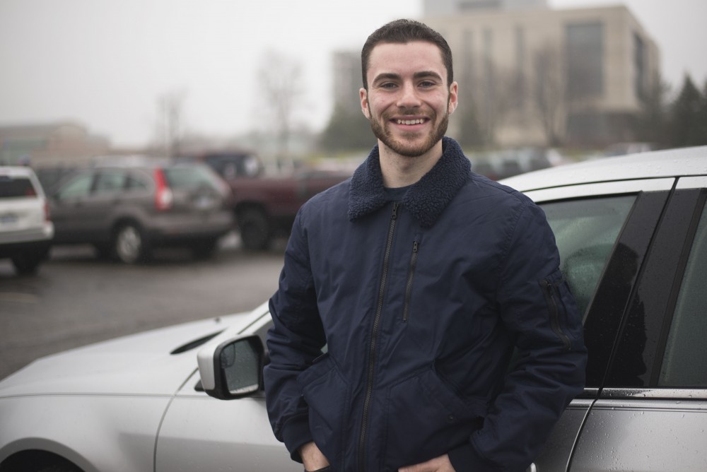 GVL / Luke Holmes - Aaron Robert poses in the parking lot outside of the Mary Idema Pew Library.