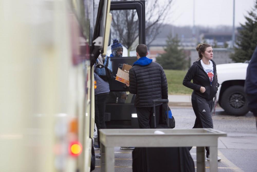 GVL / Luke Holmes - The basketball teams load the bus and set off for up north.