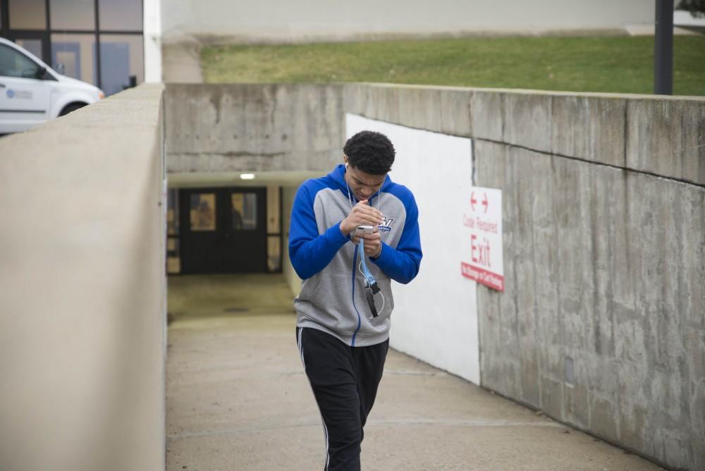 GVL / Luke Holmes - Lance Dollison (4) walks toward the bus. The basketball teams load the bus and set off for up north.