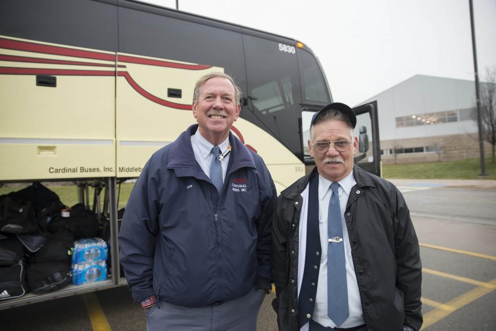 GVL / Luke Holmes - The bus drivers pose on the side of the bus before taking off.