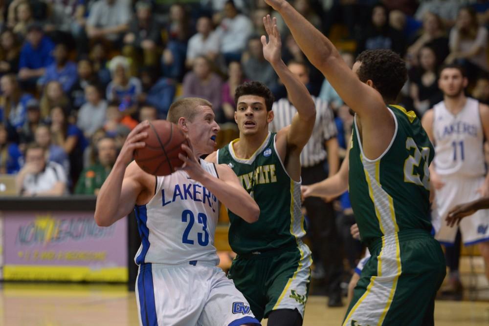 GVL / Luke Holmes - Luke Ryskamp (23) tries to make it past the defenders. GVSU men’s basketball defeated Wayne State University on Thursday, Jan.19, 2017.